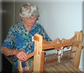 Weaver at table loom